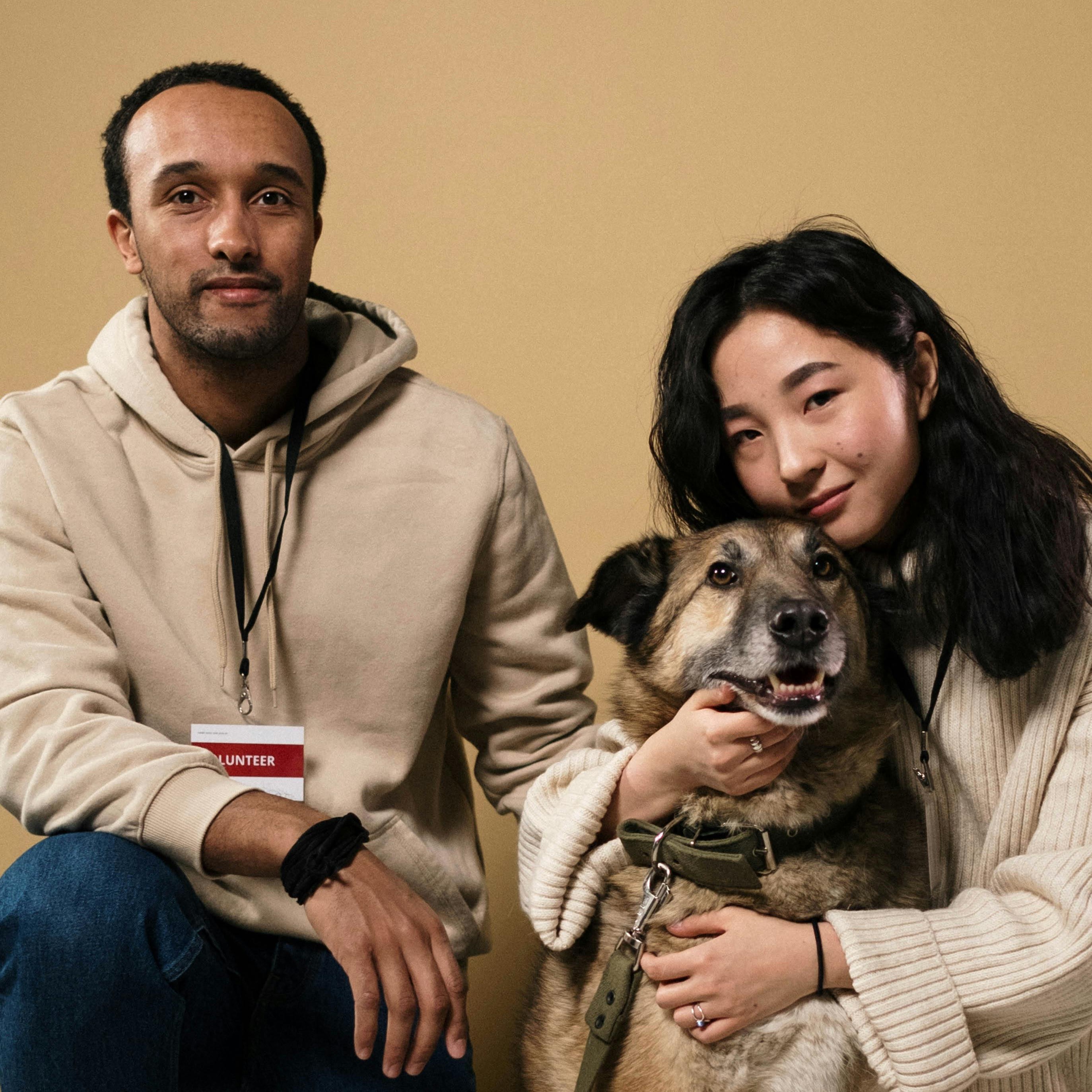 person with "volunteer shirt", hugging a dog